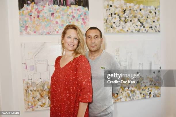 Painter Caroline Faindt and her companion actor Zinedine Soualem attend Caroline Faindt Painting Exhibition at Galerie Louis Dort on May 31, 2018 in...