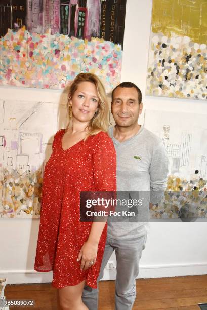 Painter Caroline Faindt and her companion actor Zinedine Soualem attend Caroline Faindt Painting Exhibition at Galerie Louis Dort on May 31, 2018 in...