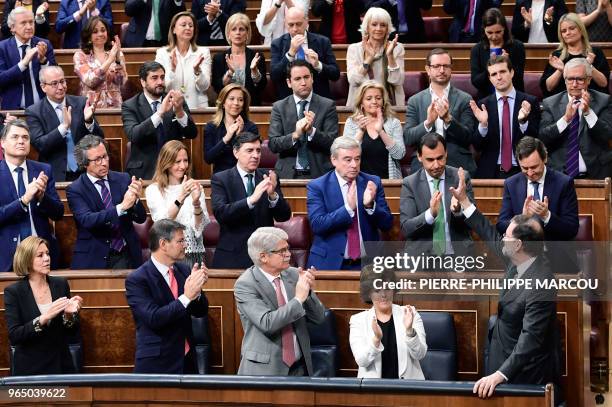 Spanish Prime Minister Mariano Rajoy acknowledges applause from Popular Party's members of parliament during a debate on a no-confidence motion at...