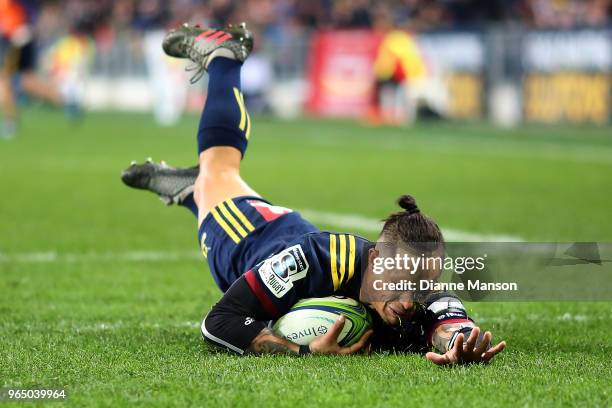 Aaron Smith of the Highlanders dives over to score a try during the round 16 Super Rugby match between the Highlanders and the Hurricanes at Forsyth...