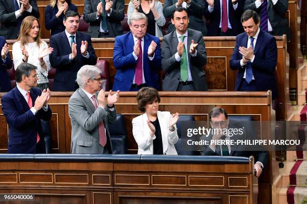 Spanish Prime Minister Mariano Rajoy acknowledges applause from Popular Party's members of parliament during a debate on a no-confidence motion at...