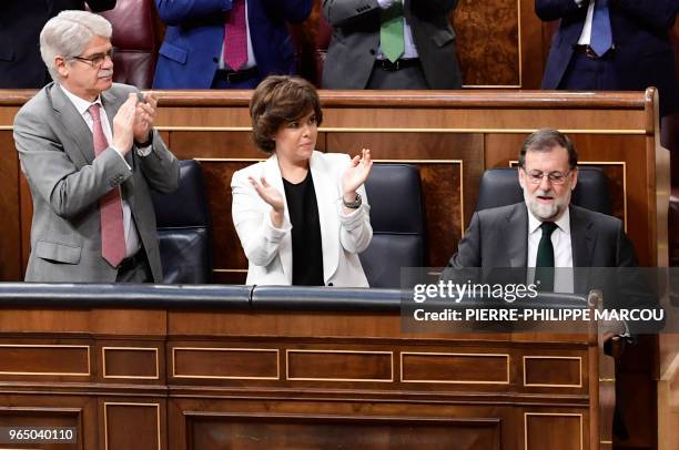 Spanish Prime Minister Mariano Rajoy acknowledges applause from Spanish Minister of Foreign Affairs Alfonso Maria Dastis and Spanish deputy pime...