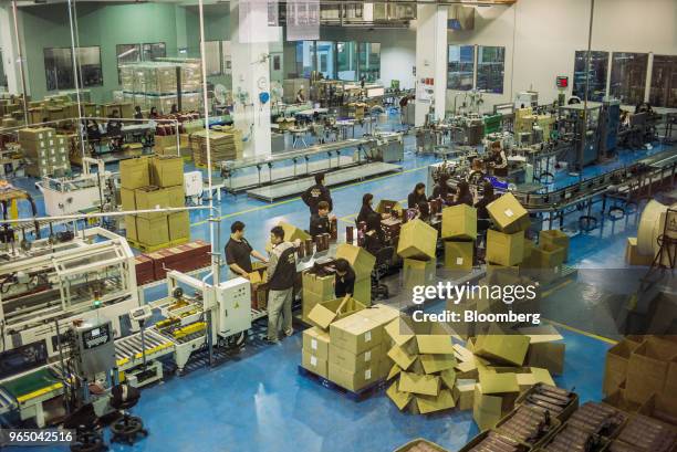 Employees package bottles of Kavalan whisky into boxes at the Kavalan Single Malt Whisky distillery in Yilan County, Taiwan, on Thursday, Jan. 25,...