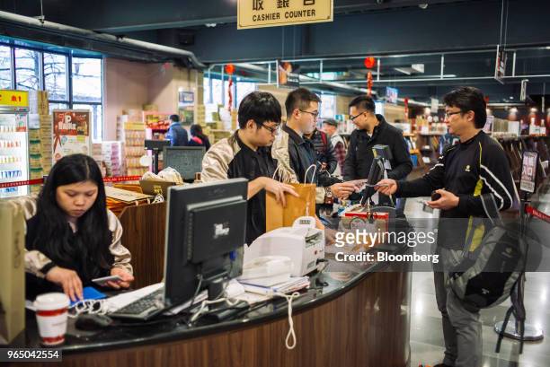 Customer makes a purchase in the retail area at the Kavalan Single Malt Whisky distillery in Yilan County, Taiwan, on Thursday, Jan. 25, 2018....