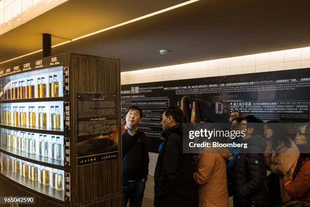 Visitors look around an exhibition display at the Kavalan Single Malt Whisky distillery in Yilan County, Taiwan, on Thursday, Jan. 25, 2018. Kavalan...