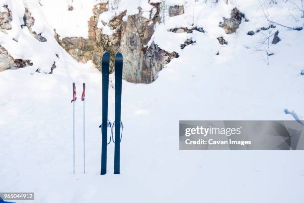 skis and ski poles on snow covered field - ski pole stock pictures, royalty-free photos & images