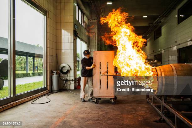 Flame burns as an employee chars a cask at the Kavalan Single Malt Whisky distillery in Yilan County, Taiwan, on Thursday, Jan. 25, 2018. Kavalan is...