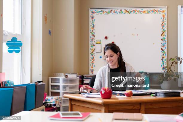 teacher in a classroom without students at school's out. - chalkboard eraser stock pictures, royalty-free photos & images