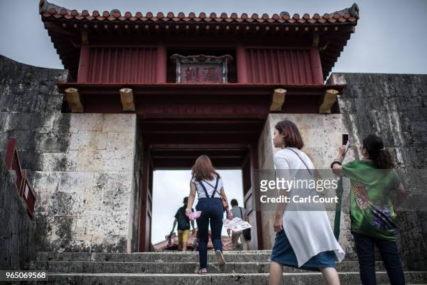 Tourists visit Shuri Castle on June 1, 2018 in Naha, Japan. Like the rest of Japan, the southern island of Okinawa has seen a recent surge in tourist...