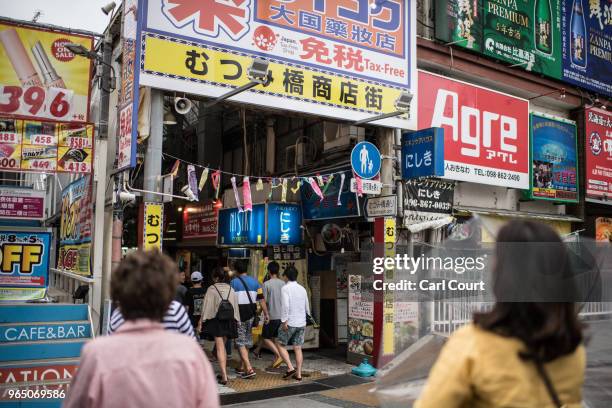 Tourists visit a shopping arcade on June 1, 2018 in Naha, Japan. Like the rest of Japan, the southern island of Okinawa has seen a recent surge in...