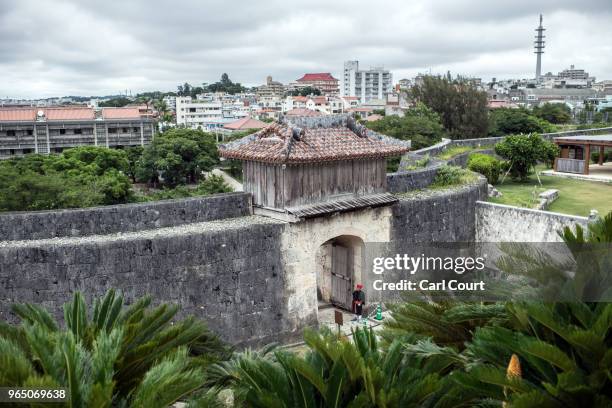 Guard in traditional Okinawan dress mans a doorway at Shuri Castle on June 1, 2018 in Naha, Japan. Like the rest of Japan, the southern island of...