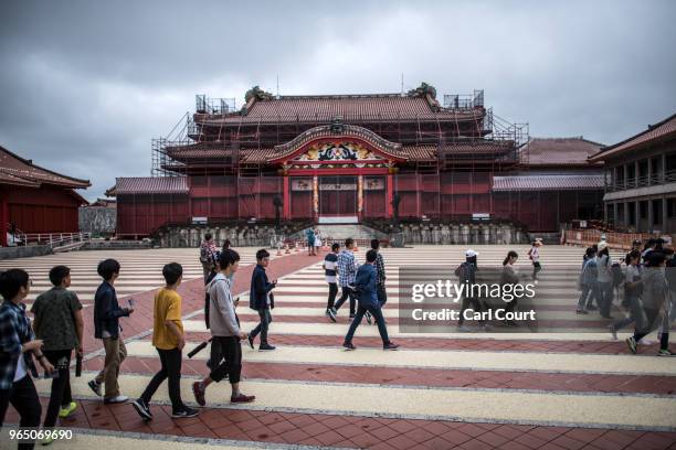 Tourists visit Shuri Castle on June 1, 2018 in Naha, Japan. Like the rest of Japan, the southern island of Okinawa has seen a recent surge in tourist...