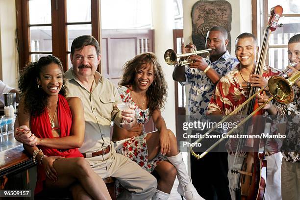 Ernest Hemingway double Brian Gordon Sinclair of Canada, poses for a photo with Cuban musicians in the Las Terrazas bar in the little fishermen...