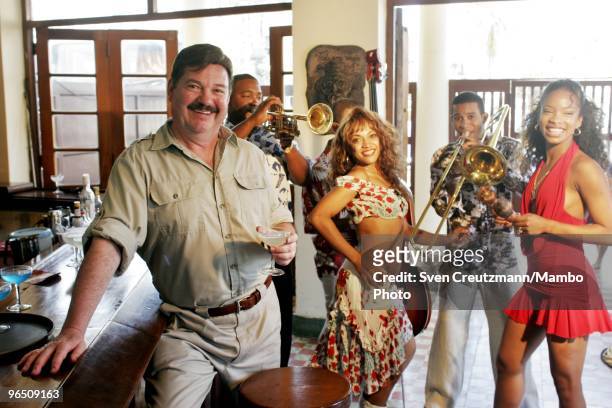 Ernest Hemingway double Brian Gordon Sinclair of Canada, poses for a photo with Cuban musicians in the Las Terrazas bar in the little fishermen...