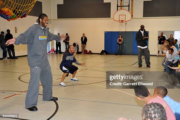 Nene and Strength and Conditioning Coach Steve Hess of the Denver Nuggets work out with students at Palmer Elementary as part of the Denver Nuggets...