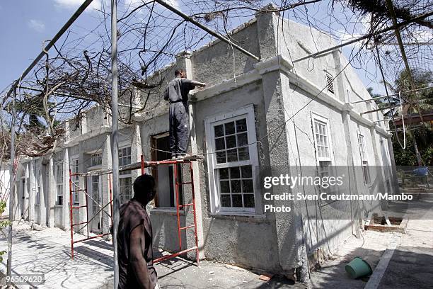 Cuban workers restore the façade of Ernest Hemingway�s house at the Finca Vigia, on March 29, 2006 in Havana, Cuba. The Hemingway Finca Vigia, now...