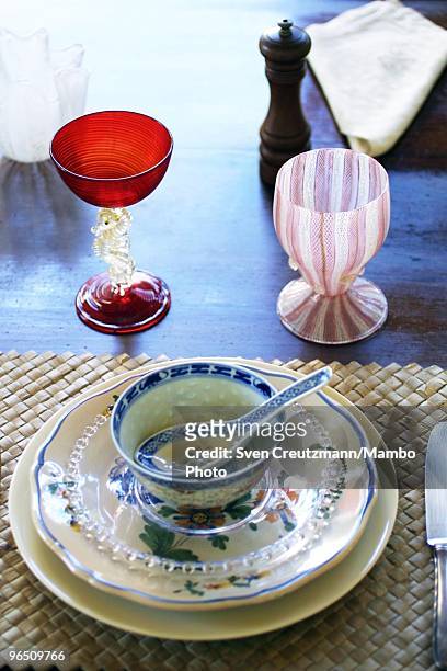 Dishes and a cup of white and red glass stand on the table of the dining-room of the Ernest Hemingway house at the Finca Vigia, on November 11, 2002...