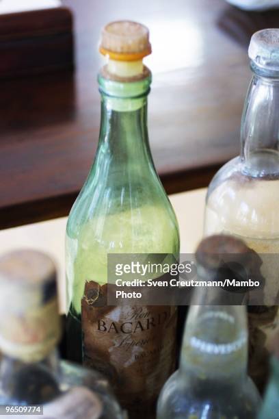 Bottle of Bacardi rum and and other alcoholic beverages stand on a table in the living room of the Ernest Hemingway house at the Finca Vigia, on...