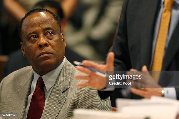 Dr. Conrad Murray looks up at his attorney Ed Chernoff as he is arraigned in the County of Los Angeles Airport Branch Courthouse on a charge of...