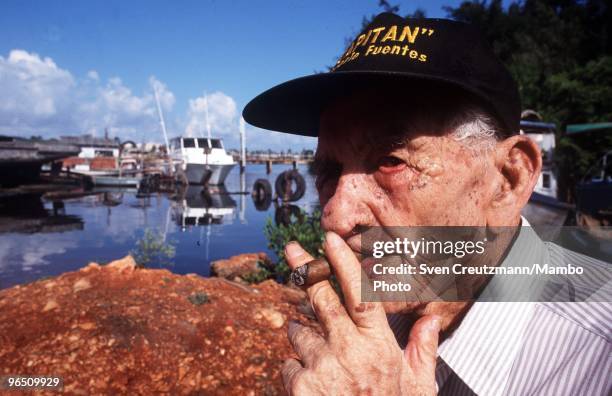 Gregorio Fuentes, former captain on Ernest Hemingway�s fishing boat Pilar, smokes a cigar at the age of 100, at his home in the little fishermen...