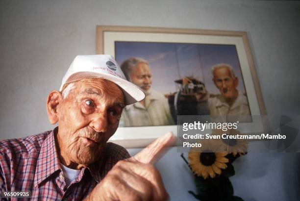 Gregorio Fuentes, former captain on Ernest Hemingway�s fishing boat Pilar, at the age of 100, gestures as he sits in his living room under a painting...