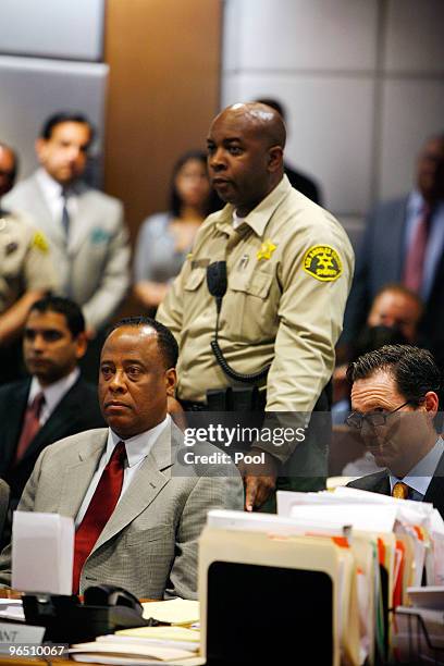 Bailiff reaches to take Dr. Conrad Murray into custody as he is arraigned in the County of Los Angeles Airport Branch Courthouse on a charge of...