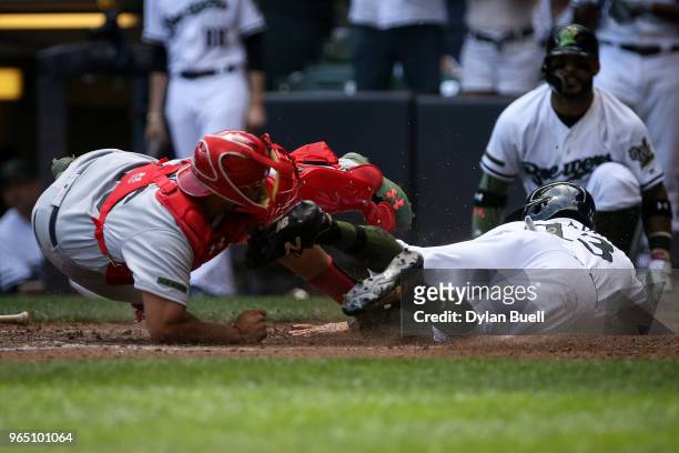 Francisco Pena of the St. Louis Cardinals tags out Tyler Saladino of the Milwaukee Brewers at home plate in the fourth inning at Miller Park on May...