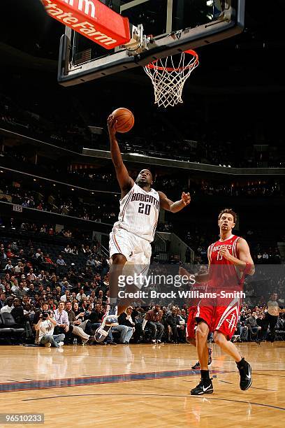 Raymond Felton of the Charlotte Bobcats lays up a shot against David Andersen of the Houston Rockets during the game on January 12, 2010 at Time...