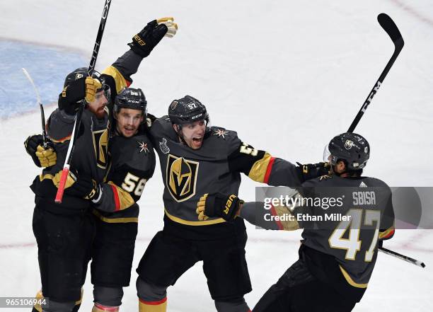 James Neal of the Vegas Golden Knights celebrates with teammates Erik Haula, David Perron and Luca Sbisa after Sbisa assisted Neal on a goal against...