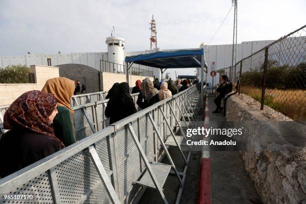 Palestinian worshippers, mostly from women wait in a queue to move for passing through the checkpoint from Bethlehem into Jerusalem after Israeli...