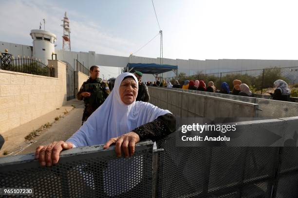 Palestinian worshippers, mostly from women wait in a queue to move for passing through the checkpoint from Bethlehem into Jerusalem after Israeli...