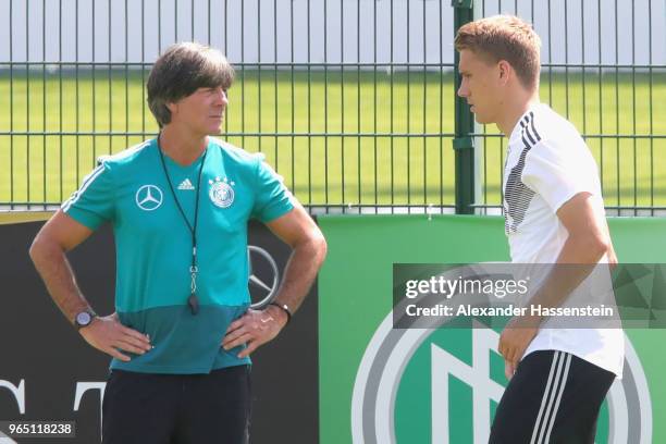 Nils Petersen runs next to Joachim Loew, head coach of the German national team during a training session of the German national team at Sportanlage...