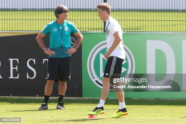 Nils Petersen runs next to Joachim Loew, head coach of the German national team during a training session of the German national team at Sportanlage...