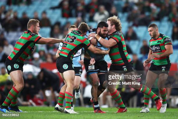 Andrew Fifita of the Sharks is tackled during the round 13 NRL match between the South Sydney Rabbitohs and the Cronulla Sharks at ANZ Stadium on...