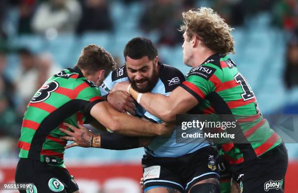 Andrew Fifita of the Sharks is tackled during the round 13 NRL match between the South Sydney Rabbitohs and the Cronulla Sharks at ANZ Stadium on...