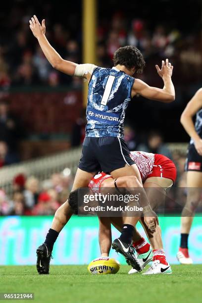 Jack Silvagni of the Blues stands over Heath Grundy of the Swans during the round 11 AFL match between the Sydney Swans and the Carlton Blues at...
