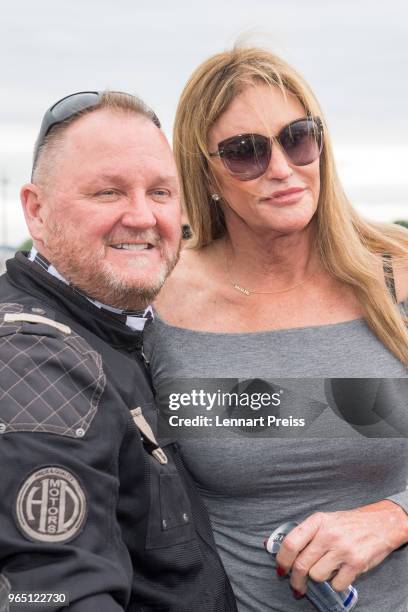 AmfAR CEO Kevin Robert Frost and Caitlyn Jenner pose during the arrival of the Life Ball plane on June 1, 2018 in Salzburg, Austria. The EpicRiders...