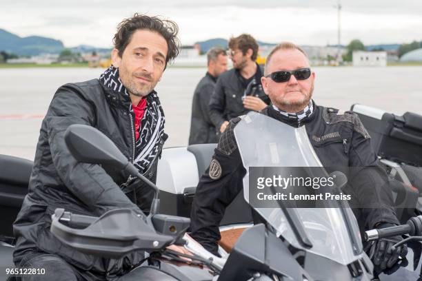 EpicRider Adrien Brody and amfAR CEO Kevin Robert Frost pose during the arrival of the Life Ball plane on June 1, 2018 in Salzburg, Austria. The...