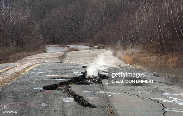 Smoke rises from a large crack in PA Highway 61, caused by the underground coal fire, February 2, 2010 in Centralia, PA. The highway, now closed,...