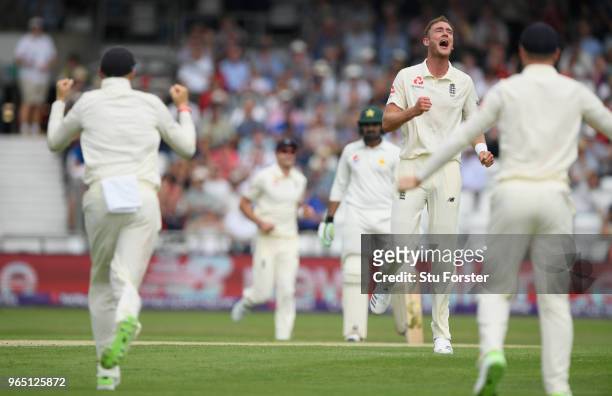 England bowler Stuart Broad celebrates with captain Joe Root after taking the wicket of Azhar Ali during day one of the second Test Match between...