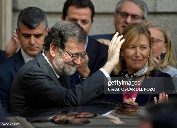 Spanish out-going Prime Minister Mariano Rajoy leaves after a vote on a no-confidence motion at the Lower House of the Spanish Parliament in Madrid...