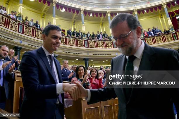 Spain's new Prime Minister Pedro Sanchez shakes hands with Spain's out-going Prime Minister Mariano Rajoy after a vote on a no-confidence motion at...