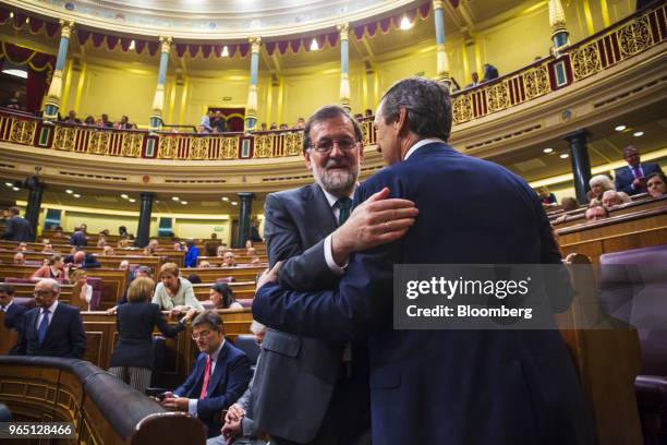 Mariano Rajoy, president of Spain, left, embraces Rafael Hernando, spokesperson of the People's Party , during a no-confidence motion vote at...