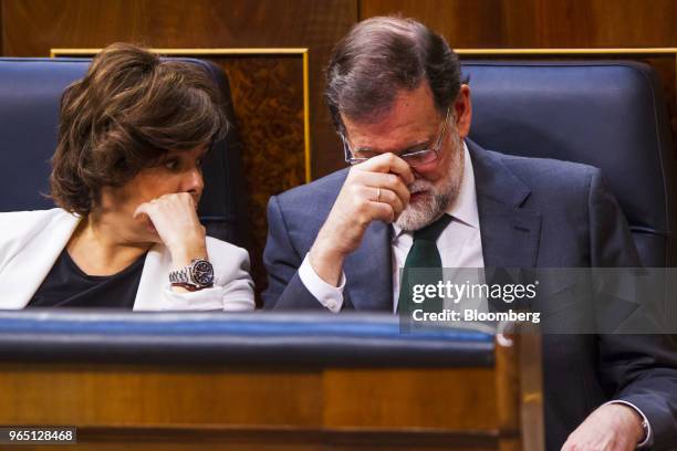 Mariano Rajoy, president of Spain, right, reacts as he speaks with Soraya Saenz de Santamaria, Spain's deputy prime minister, during a no-confidence...