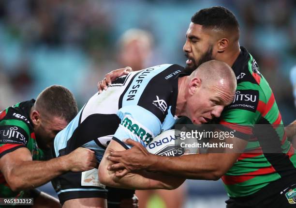 Luke Lewis of the Sharks is tackled by Robert Jennings of the Rabbitohs during the round 13 NRL match between the South Sydney Rabbitohs and the...