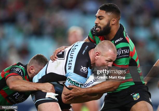 Luke Lewis of the Sharks is tackled by Robert Jennings of the Rabbitohs during the round 13 NRL match between the South Sydney Rabbitohs and the...