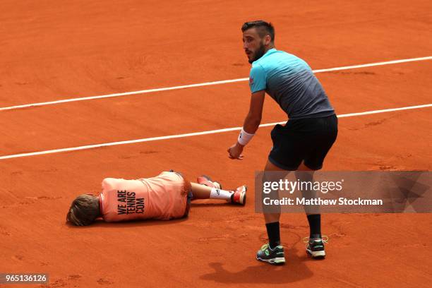 Damir Dzumhur of Bosnia and Herzegovinia colides with a ball boy during his mens singles third round match against Alexander Zverev of Germany during...