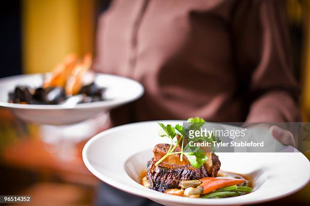 waitress holding plate of beef tenderloin - carbondale colorado bildbanksfoton och bilder