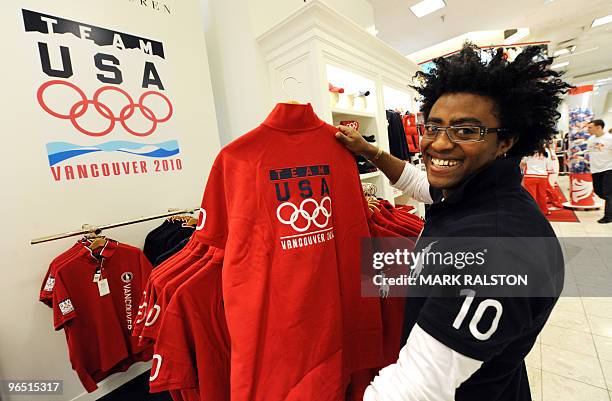 An employee holds a Team USA Winter Olympic t-shirt at the Hudson's Bay department store in downtown Vancouver on February 7, 2010. Winter Olympics...