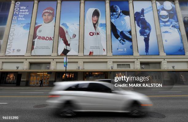 Traffic pass a Winter Olympic promotion on the outside of the Hudson Bay department store in downtown Vancouver on February 7, 2010. Winter Olympics...